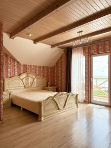 a bedroom with a large bed and a large window at Kurenas in Juodkrantė