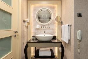 a bathroom with a sink and a mirror at Limak Eurasia Luxury Hotel in Istanbul