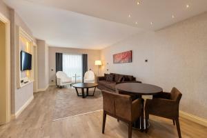 a living room with a couch and a table at Limak Eurasia Luxury Hotel in Istanbul