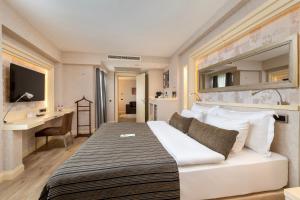 a hotel room with a bed and a desk at Limak Eurasia Luxury Hotel in Istanbul