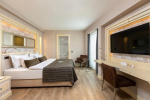 a hotel room with a bed and a flat screen tv at Limak Eurasia Luxury Hotel in Istanbul
