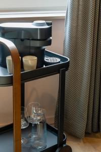 a shelf with glasses on it with a coffee maker at Little Jack Boutique Studios in Valkenburg +35 photos