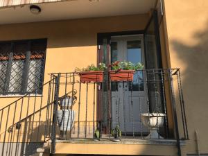 a balcony with two potted plants on a door at R&B MiDora Montale in Montale