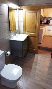 a bathroom with a white toilet and a sink at Dimitras house palaiopoli in Kythira