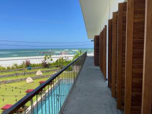 a balcony with a view of the beach and the ocean at Marshmallow Bay Boutique Hotel & Surf Point Adults Only in Ahangama