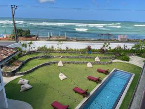 a view of a swimming pool with chairs and the ocean at Marshmallow Bay Boutique Hotel & Surf Point Adults Only in Ahangama +37 photos