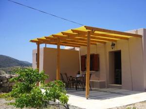 a wooden pergola on a patio of a house at Dimitras house palaiopoli in Kythira