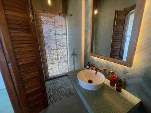 a bathroom with a sink and a mirror at Marshmallow Bay Boutique Hotel & Surf Point Adults Only in Ahangama