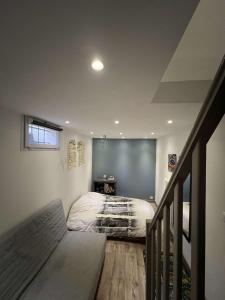 a bedroom with a bed in a room with a staircase at Maison villa avec piscine et spa, 8 à 10 personnes in LʼIsle-sur-la-Sorgue