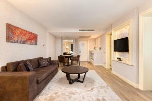 a living room with a couch and a table at Limak Eurasia Luxury Hotel in Istanbul