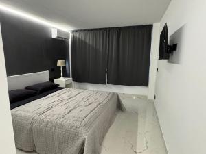 a bedroom with a bed and a black wall at Suit home Archimede in Palermo
