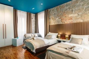 Posteľ alebo postele v izbe v ubytovaní Riva Luxury Rooms