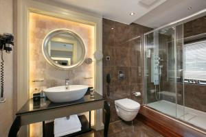 a bathroom with a sink and a toilet and a shower at Limak Eurasia Luxury Hotel in Istanbul