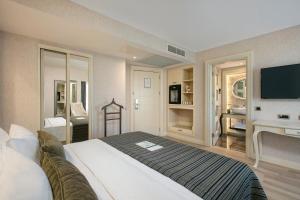 a bedroom with a large bed and a tv at Limak Eurasia Luxury Hotel in Istanbul