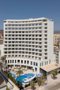 a large white building with two swimming pools at Hotel RH Arena - Todo Incluido in Gandía