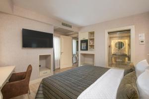 a hotel room with a bed and a flat screen tv at Limak Eurasia Luxury Hotel in Istanbul