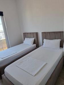 twee bedden naast elkaar in een kamer bij Ada’s house in Durrës +14 foto's