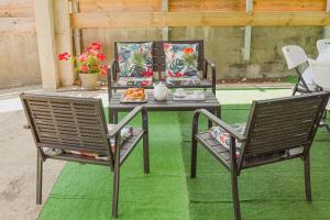 a table with two chairs and a table with food on it at Eclats d'Etoiles - Rooftop - Piscine - By Sister Home in Saint-Pierre