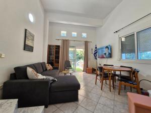a living room with a couch and a table at Relax Dream Villa-House, Apartement, Studio in Kallithea Halkidikis