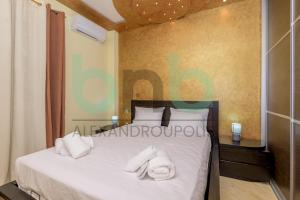 a bedroom with a bed with white towels on it at Premium 2 BR Apartment in Alexandroupoli