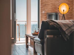 a living room with a couch and a table with wine glasses at Villa Friede-Marie, Ostseeweitblick in Sassnitz