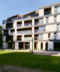 a large building with a park in front of it at Polanica Park - LAGUNA - PREMIUM in Polanica-Zdrój