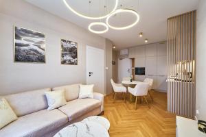 a living room with a couch and a table at Polanica Park - LAGUNA - PREMIUM in Polanica-Zdrój