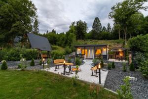 a backyard with a tiny house with a patio at Nature Loft in Porumbacu de Sus
