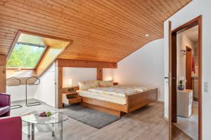 a bedroom with a bed and a wooden ceiling at Gästehaus Gaby in Bad Bellingen