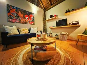 a living room with a table and a couch at The Zen-Den - Subtle Charm & Luxury in Bryanston in Johannesburg