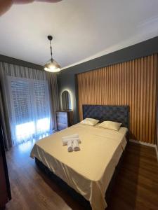 a bedroom with a bed with two towels on it at J K E apartments in Pristina +7 photos