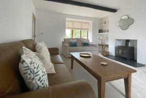 a living room with a couch and a table at Mill House in Braithwaite