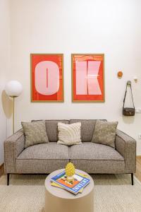 a living room with a couch and a table at Castle District Design Studio in Budapest