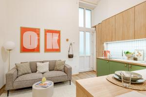 a living room with a couch and a kitchen at Castle District Design Studio in Budapest