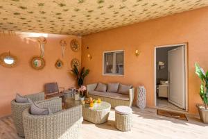 a living room with a couch and chairs at Villa Karteris by Villa Plus in Stalida