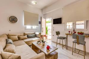 a living room with a couch and a table at Villa Karteris by Villa Plus in Stalida