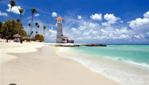 a beach with a lighthouse in the middle of the water at Las Palmeras in La Laguna