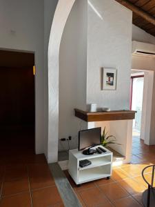 a room with a white table with a laptop on it at Casa Degebe - Casas da Amieria in Amieira +4 photos