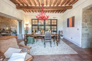 a dining room with a table and a chandelier at Dimora Belvedere in Montecatini Terme