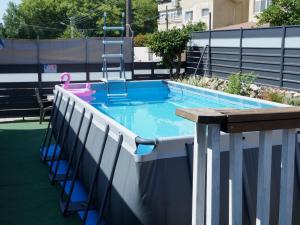 a swimming pool with a pink swan and a pink float at הצימר של אביבה - צימר לזוגות ומשפחות עם בריכה פרטית, סאונה וג'קוזי in Qiryat Shemona