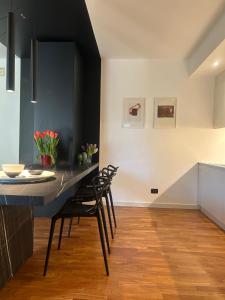a kitchen with a dining table and chairs at The Perfect Corner in Pordenone +16 photos