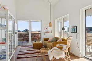 a living room with a couch and a table at Feriehus 1135 in Ringkøbing