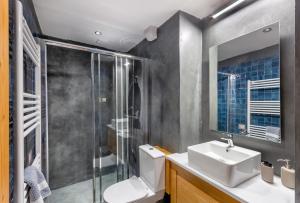 a bathroom with a toilet and a sink and a shower at Starry Land in Vitsa