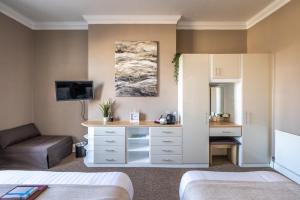a hotel room with a bed and a desk at The Cumberland in Weymouth