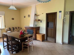 a living room with a table and a fireplace at Rifugio Lunare in Lauria Inferiore