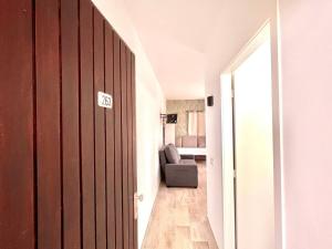 a hallway with a door and a chair in a room at Precioso Estudio con Terraza Privada y BBQ en Costa del Silencio in Costa Del Silencio +14 photos