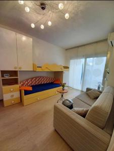 a bedroom with a couch and a bed and a table at Casa Nilva Holiday in Sanremo in Sanremo