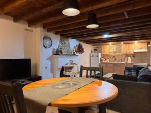 a kitchen and a table with a wine glass on it at Pete's Guest House in Megara