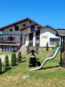 a building with a slide in front of it at Casa Dunca in Sighetu Marmaţiei