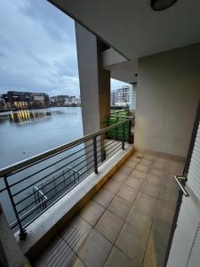 a balcony with a view of a body of water at Lakeside 2 Bedroom apartment in Tyger Valley